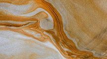 Swirling golden patterns representing collaboration and scaling impact